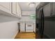 Compact kitchen with white cabinets, white appliances, and granite countertops at 3501 Wesley Chapel Rd, Decatur, GA 30034