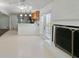 Open concept living area with fireplace, tiled floor and adjacent kitchen space at 3501 Wesley Chapel Rd, Decatur, GA 30034