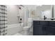 Clean bathroom with a shower-tub combo, gray vanity, and modern fixtures at 4220 Provenance Trl, Cumming, GA 30028