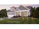 Beautiful two-story home featuring a manicured lawn, attached garage, and a charming front porch at 4220 Provenance Trl, Cumming, GA 30028
