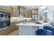 Modern kitchen featuring stainless steel appliances, a center island with seating, and custom cabinetry at 4220 Provenance Trl, Cumming, GA 30028