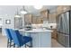 Stylish kitchen with a center island, stainless steel refrigerator, custom cabinets and stainless steel appliances at 4220 Provenance Trl, Cumming, GA 30028