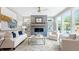 Bright living room with large windows, a fireplace, comfortable seating, and stylish decor at 4220 Provenance Trl, Cumming, GA 30028