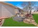 Side view of a well-maintained backyard with tiered planting beds and a lush lawn at 46 Centerport Dr, White, GA 30184