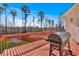 Spacious outdoor deck with a grill overlooking the backyard and scenic wooded area on a clear day at 46 Centerport Dr, White, GA 30184