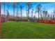 Expansive backyard with lush green grass, wood fence, and ample space for recreation at 46 Centerport Dr, White, GA 30184