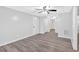 Finished basement with gray wood-look flooring, ceiling fans, and white doors at 46 Centerport Dr, White, GA 30184