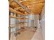 Unfinished basement space with open ceiling, built-in shelves, and concrete floor at 46 Centerport Dr, White, GA 30184