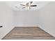 Clean, empty basement with gray wood-look flooring and simple ceiling fan at 46 Centerport Dr, White, GA 30184