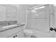 Bright bathroom featuring granite countertop, white cabinets, toilet and sliding glass shower door at 46 Centerport Dr, White, GA 30184