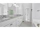 Bathroom with double sinks, granite countertop, and modern fixtures at 46 Centerport Dr, White, GA 30184