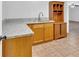 Ample counter space with granite countertops and natural wood cabinets, providing storage at 46 Centerport Dr, White, GA 30184