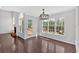 Bright dining room featuring hardwood floors, a modern chandelier, and large windows with a view at 46 Centerport Dr, White, GA 30184