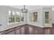 Bright dining room featuring hardwood floors, a modern chandelier, and large windows with a view at 46 Centerport Dr, White, GA 30184