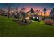 Single Gathering home at dusk, with green lawn and professional landscaping at 46 Centerport Dr, White, GA 30184
