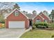 Well maintained single Gathering brick home with two-car garage and manicured lawn at 46 Centerport Dr, White, GA 30184