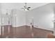 Open-concept living room with hardwood floors, fireplace, high ceiling, and ample natural light at 46 Centerport Dr, White, GA 30184