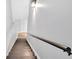 This staircase features wood treads, metal handrail, and is lit with a modern wall sconce at 46 Centerport Dr, White, GA 30184