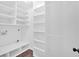 Spacious walk-in closet with custom shelving and wood-look flooring at 46 Centerport Dr, White, GA 30184
