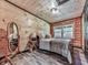 Cozy bedroom with a queen bed, natural light, and rustic decor, creating a serene retreat at 1166 Upper Sweetwater Se Trl, White, GA 30184