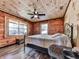 Inviting bedroom with a queen bed, natural light, and rustic wooden walls, a tranquil space to relax at 1166 Upper Sweetwater Se Trl, White, GA 30184