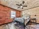 Comfortable bedroom with a queen bed, wood accents, and natural light, creating a warm and inviting atmosphere at 1166 Upper Sweetwater Se Trl, White, GA 30184