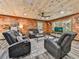Beautiful living room featuring comfortable seating, a ceiling fan, and natural light from large windows at 1166 Upper Sweetwater Se Trl, White, GA 30184
