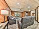 Comfortable living room with wood walls, a ceiling fan, and a large window for natural lighting at 1166 Upper Sweetwater Se Trl, White, GA 30184