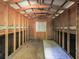 Unfinished outbuilding interior with wood framing and partial plywood flooring at 1166 Upper Sweetwater Se Trl, White, GA 30184