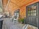 Inviting front porch with rocking chairs, rustic wooden walls, and a 'Welcome Gathering' sign at 1166 Upper Sweetwater Se Trl, White, GA 30184