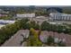 An aerial view highlighting the apartment complex within a vibrant cityscape and lush foliage surroundings at 1250 Parkwood Cir # 2312, Atlanta, GA 30339