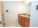 Bathroom features a granite countertop and a large mirror over a sink and wooden cabinets at 1250 Parkwood Cir # 2312, Atlanta, GA 30339