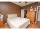 Bedroom has closet with an organized closet and a wooden dresser with colorful art pieces on top at 1250 Parkwood Cir # 2312, Atlanta, GA 30339