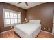 Cozy bedroom features a ceiling fan, natural light from the window, and hardwood floors at 1250 Parkwood Cir # 2312, Atlanta, GA 30339