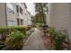 Landscaped grounds with a sidewalk leading to condo buildings and a community barbeque at 1250 Parkwood Cir # 2312, Atlanta, GA 30339