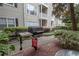 Grill on condo grounds features a fire blanket and outdoor seating at 1250 Parkwood Cir # 2312, Atlanta, GA 30339