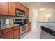 Modern kitchen with stainless steel appliances and granite countertops near the entry doors at 1250 Parkwood Cir # 2312, Atlanta, GA 30339
