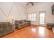 Bright living room with hardwood floors, ceiling fan, and access to a balcony at 1250 Parkwood Cir # 2312, Atlanta, GA 30339