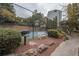 Community tennis court with a grill, bench, and surrounding landscaped grounds for leisure and recreation at 1250 Parkwood Cir # 2312, Atlanta, GA 30339