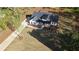 Stunning aerial view of a modern farmhouse with a well-manicured lawn and charming curb appeal at 1632 Oleander Sw Dr, Lilburn, GA 30047