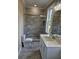 Newly remodeled bathroom with stone look tile, rainfall shower head and luxurious fixtures at 1632 Oleander Sw Dr, Lilburn, GA 30047