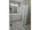 Beautiful primary bathroom with double sinks, walk-in shower, and marble look tiles at 1632 Oleander Sw Dr, Lilburn, GA 30047