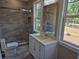 Newly remodeled bathroom with stone look tile, rainfall shower head and luxurious fixtures at 1632 Oleander Sw Dr, Lilburn, GA 30047