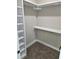 Walk-in closet with shelving for storage, and carpet flooring at 1632 Oleander Sw Dr, Lilburn, GA 30047