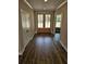 Hallway with wood floors leading to a front door and rooms filled with natural light at 1632 Oleander Sw Dr, Lilburn, GA 30047