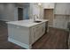 Close-up of the kitchen island with a sink, storage, and seating area at 1632 Oleander Sw Dr, Lilburn, GA 30047