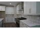 Modern kitchen featuring white cabinets, stainless steel appliances, and beautiful countertops at 1632 Oleander Sw Dr, Lilburn, GA 30047