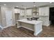 Spacious kitchen with a center island, white cabinetry, and stylish pendant lighting at 1632 Oleander Sw Dr, Lilburn, GA 30047