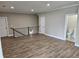 Open-concept living area with wood floors, modern railings, and access to a bathroom, offering functionality at 1632 Oleander Sw Dr, Lilburn, GA 30047