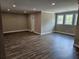Spacious living room featuring hardwood floors, recessed lighting, and large windows showcasing a bright, open space at 1632 Oleander Sw Dr, Lilburn, GA 30047